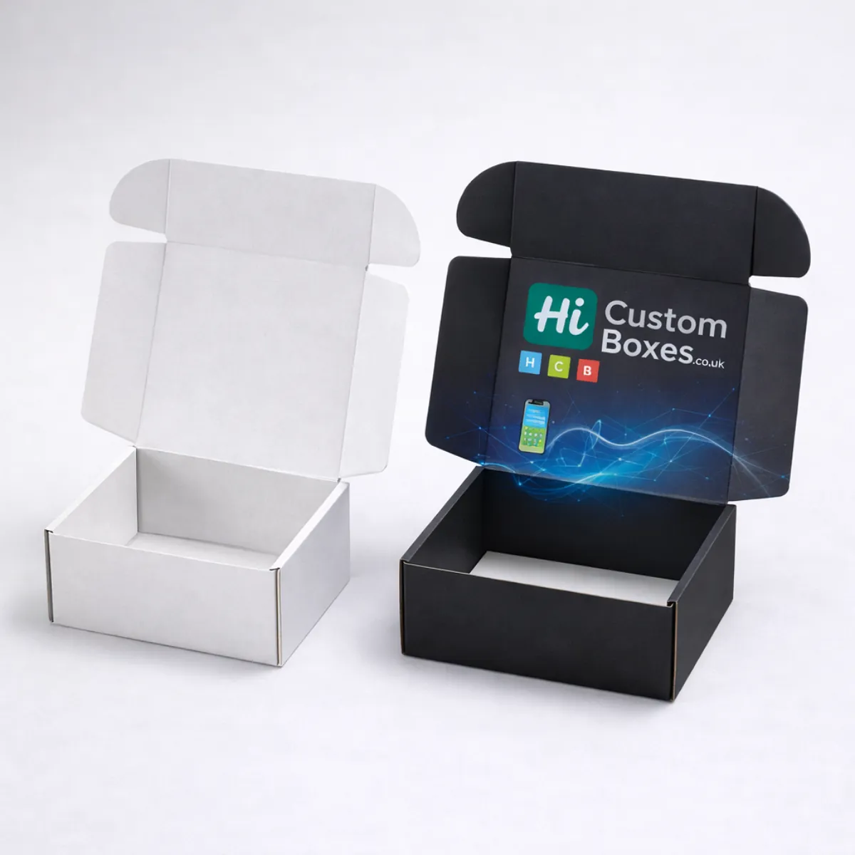 Two open mailing boxes side by side- one plain white and one printed in matte black- class=